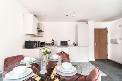 a dining room with a glass table and chairs at Lovely 1 Bed Central Preston Apartment in Preston