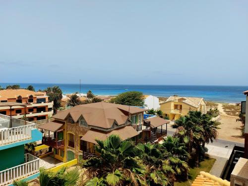an aerial view of a beach with houses and the ocean at Branco Sea Holiday Apartments in Santa Maria