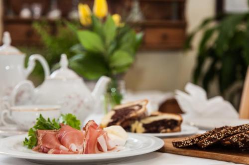 a table with two plates of food on it at Hotel Comfort Erica Dolomiti Val d'Adige in Salorno sulla Strada del Vino