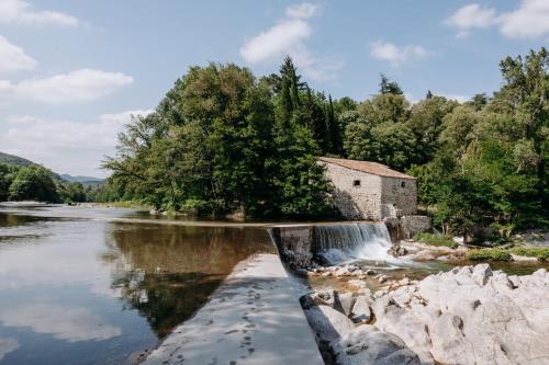 an old building on the side of a river at Slow Village Anduze - Cévennes in Corbés