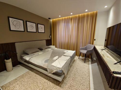 a bedroom with a bed and a desk and a television at Diamond Beach Sarafovo by KP - Luxury Collection, Apt 5 in Burgas