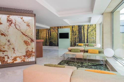 a room with four beds and a wall mural at HF Fenix Garden in Lisbon