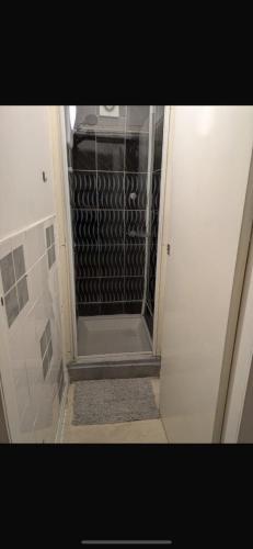 a walk in shower with a glass door in a bathroom at MyRoomz Orchid Hotel in Blackpool