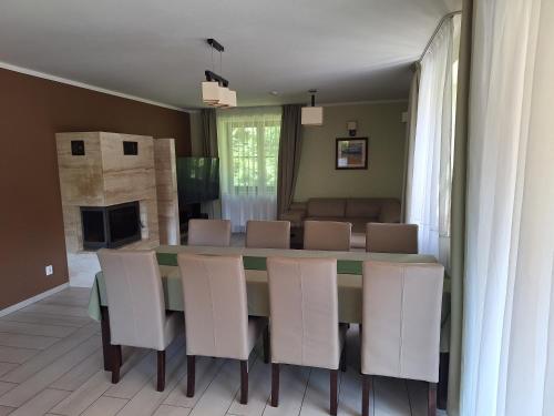 a dining room with a table and chairs at Ośrodek Szkoleniowo-Wypoczynkowy "Leśnik" in Ustka