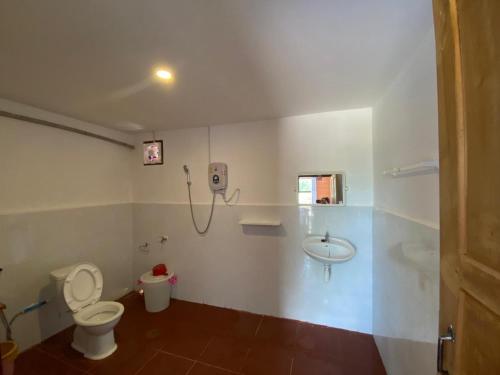 a bathroom with a toilet and a sink at Cool Pool Bungalow in Ban Phônmuang