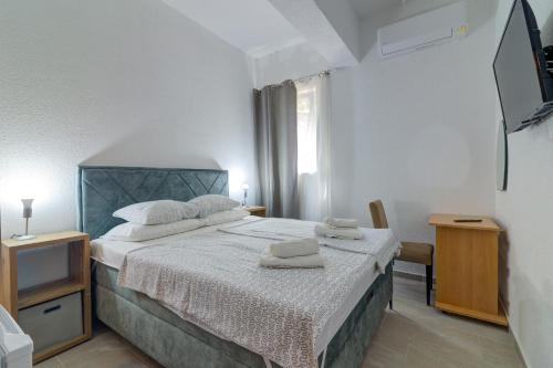a bedroom with a bed with two towels on it at Vila DADA 2 in Senj