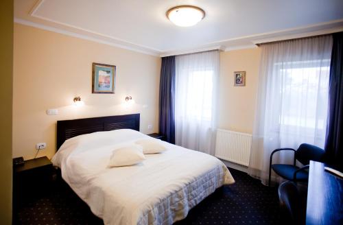 Postel nebo postele na pokoji v ubytování Hotel Parc Tecuci