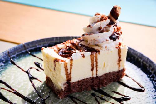 a piece of cake on a plate on a table at Hotel Clipa in Drobeta-Turnu Severin