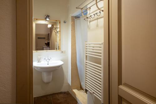 a bathroom with a sink and a mirror at La Locanda di Villa Toscana in Bibbona