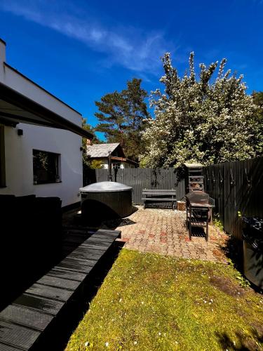 a backyard with a table and a bench and a fence at Villa Gauja - holiday home close to the sea and lake in Gauja