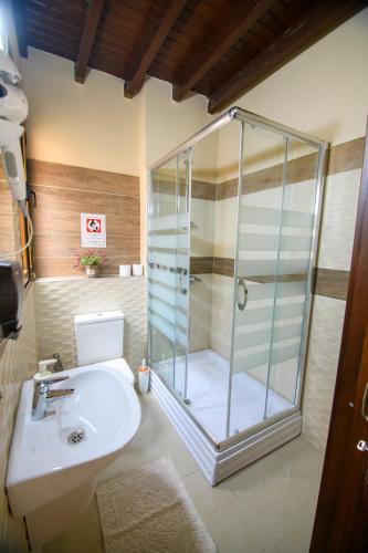 a bathroom with a shower and a toilet and a sink at DENGE Homes in Lefkosa Turk