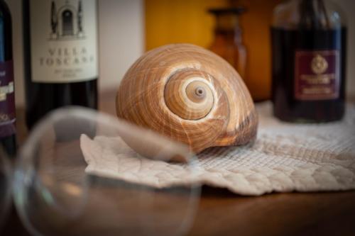 a snail sitting on a table with a glass at La Locanda di Villa Toscana in Bibbona