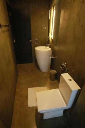 a bathroom with a white sink and a toilet at BBQ HUB Ella in Ella
