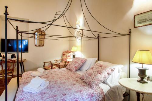 a bedroom with a large bed with a canopy at La Locanda di Villa Toscana in Bibbona