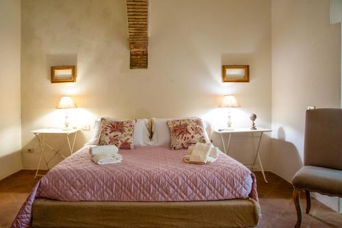 a bedroom with a bed with two lamps on it at La Locanda di Villa Toscana in Bibbona