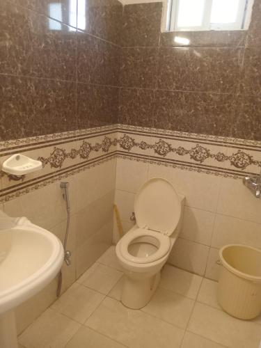 a bathroom with a toilet and a sink at Abbasi guest house in Murree