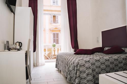 a bedroom with a bed and a large window at 47 Steps in Rome