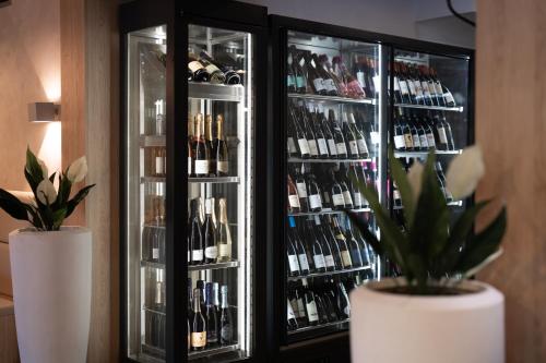 a refrigerator filled with lots of bottles of wine at Penzion a restaurace Bílý Mlýn in Liberec