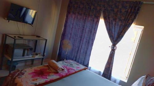 Ένα ή περισσότερα κρεβάτια σε δωμάτιο στο Olikaya Guest House Groblersdal