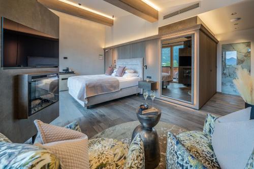 a bedroom with a bed and a living room at Hotel Post in Kaltenbach