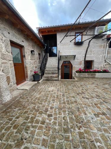 a stone building with a stone floor and a door at Eido de Bairros - Casa Vinha da Touça T1 in Soajo