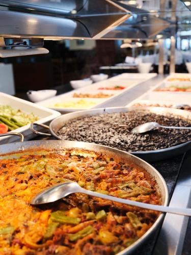 a buffet line with many different dishes of food at Prestige Victoria in Roses