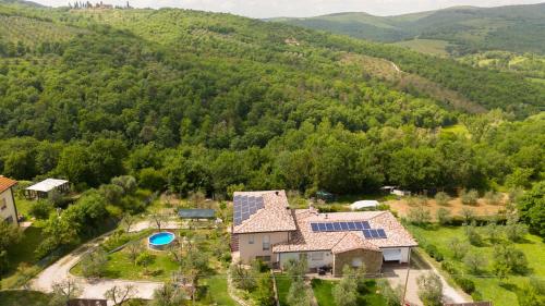 an aerial view of a house with solar panels on its roof at Villino Aurora by VacaVilla in Ciggiano