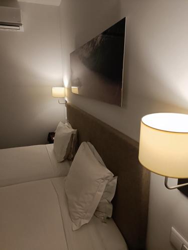 a hotel room with a bed with a picture on the wall at Hotel Porto Santo & Spa in Porto Santo