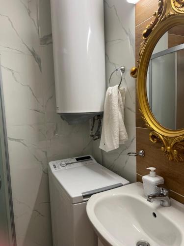 a bathroom with a toilet and a sink and a mirror at Sweet Homes 6 in Sunny Beach