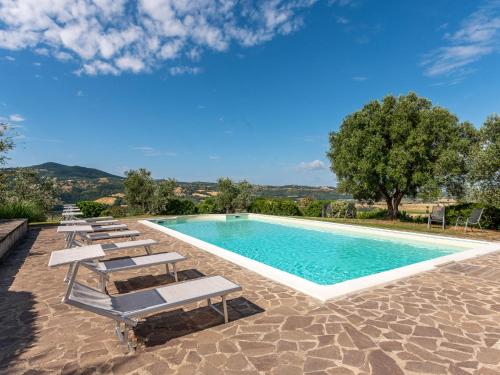 a swimming pool with chaise lounge chairs and a pool at Holiday Home Casa dell'Orto by Interhome in Case Bardi