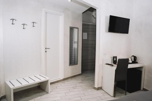 a white room with a desk and a television at 47 Steps in Rome