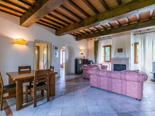 a living room with a couch and a table at Villa Villa Elena-1 by Interhome in Le Vedute