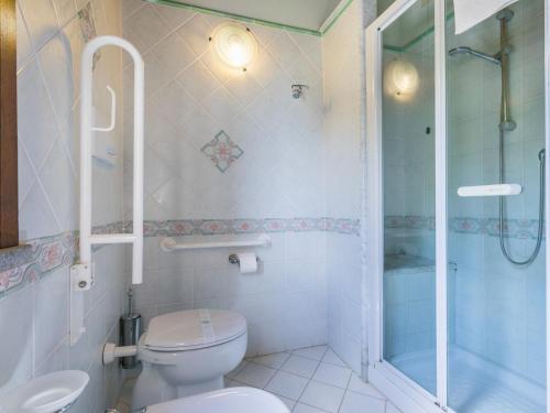a bathroom with a toilet and a glass shower at Villa Villa Elena-1 by Interhome in Le Vedute