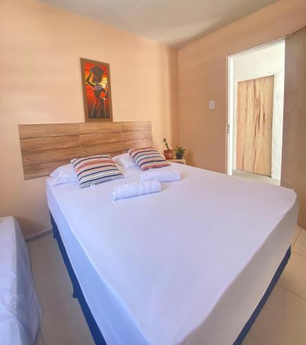 a large white bed in a room with a window at Pousada Sete Mares Manaira in João Pessoa