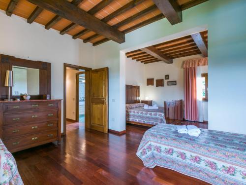 a bedroom with two beds and a dresser in a room at Villa Villa Elena-1 by Interhome in Le Vedute