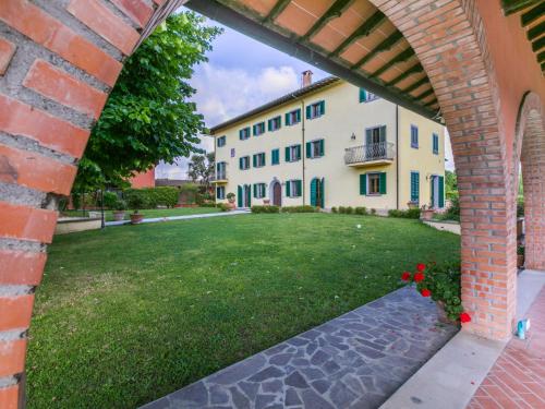 an archway leading into a yard with a building at Villa Villa Elena-1 by Interhome in Le Vedute