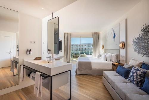 a hotel room with a bed and a living room at Barceló Playa Blanca in Playa Blanca