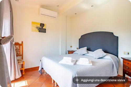 a bedroom with a large bed with two pillows on it at I like Chopin apartments in Fiumicino