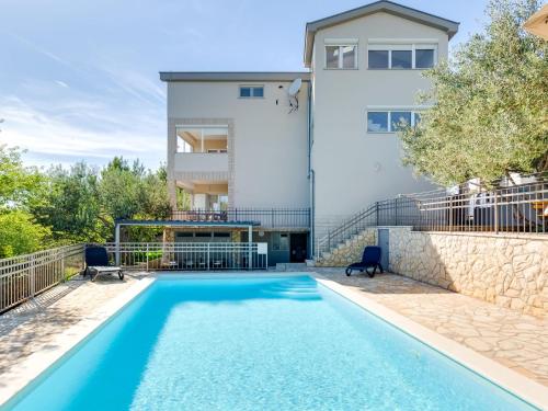 an apartment with a swimming pool in front of a building at Apartment Relax-1 by Interhome in Maslenica