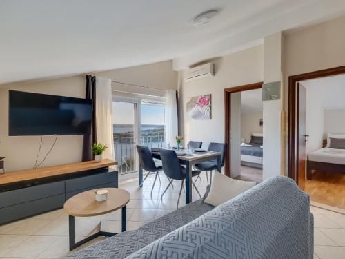 a living room with a couch and a table at Apartment Relax-1 by Interhome in Maslenica