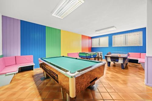 a room with a pool table and colorful walls at Aparthotel Des Alpes in Cavalese