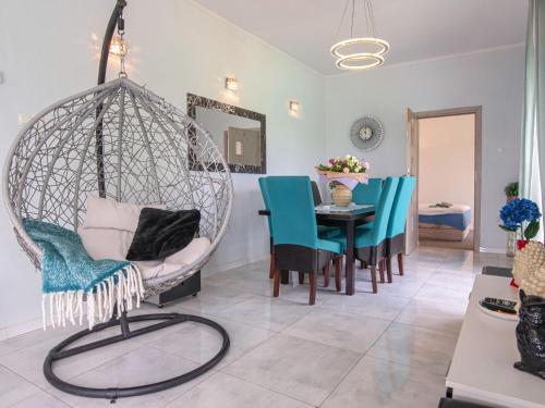 a room with a hanging chair and a table at Holiday Home Butterfly Lux by Interhome in Dobra