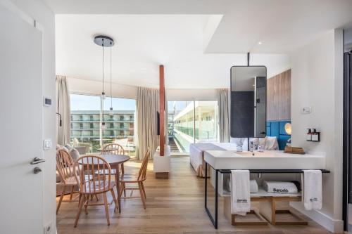 a bathroom with a sink and a table in a room at Barceló Playa Blanca in Playa Blanca