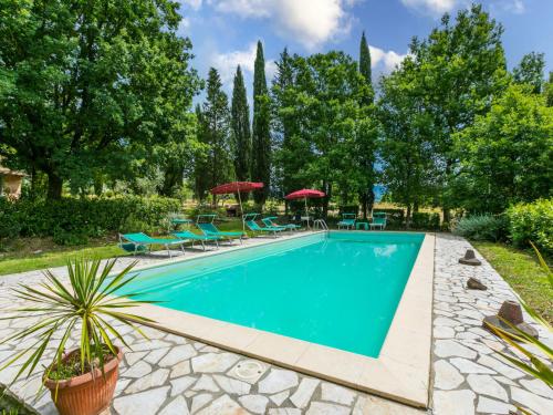 a swimming pool in a yard with chairs and umbrellas at Holiday Home Tenuta La Colonna by Interhome in Ponte di Masino