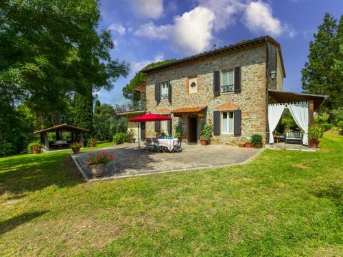 an external view of a stone house with a patio at Holiday Home Tenuta La Colonna by Interhome in Ponte di Masino