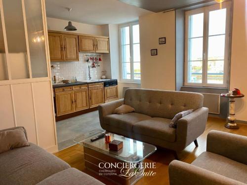 a living room with two couches and a table at La Passerelle in Cherbourg en Cotentin