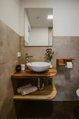 a bathroom with a white sink and a mirror at Motel Sleep Inn in Töging am Inn