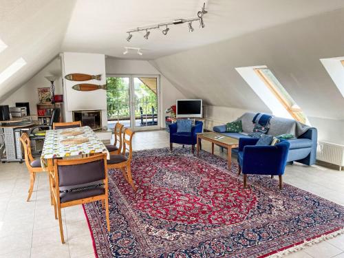 a living room with a table and chairs and a couch at Apartment Carola by Interhome in Godern