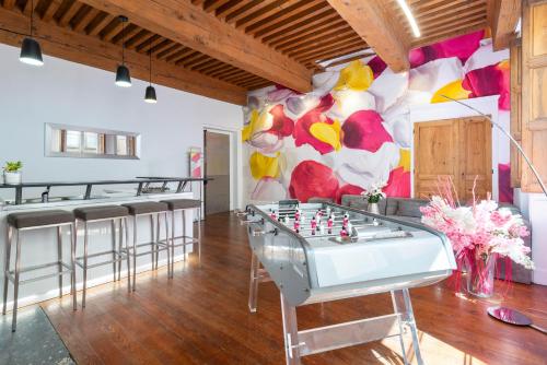 a room with a foosball table and a mural at le XVI de la Rose in Lyon