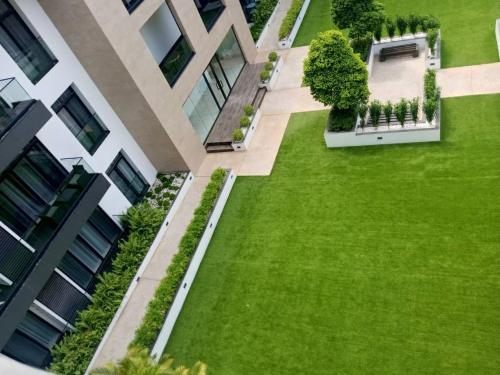 an aerial view of a green lawn in front of a building at Embassy Gardens Royal Suites Apartments in Accra
